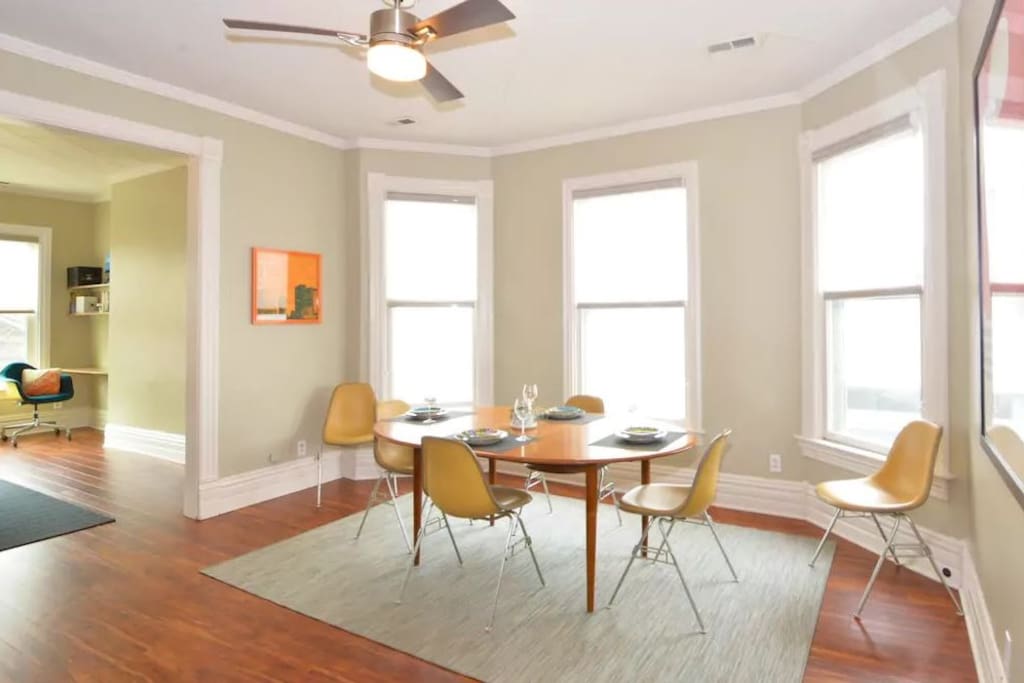The separate dining room features an expandable table and vintage Herman Miller chairs.