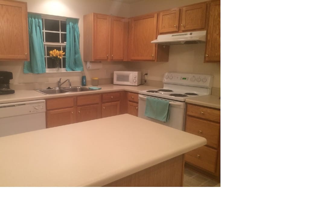 Kitchen is well equipped and the island gives you plenty of work space. The table is to the right of the island.