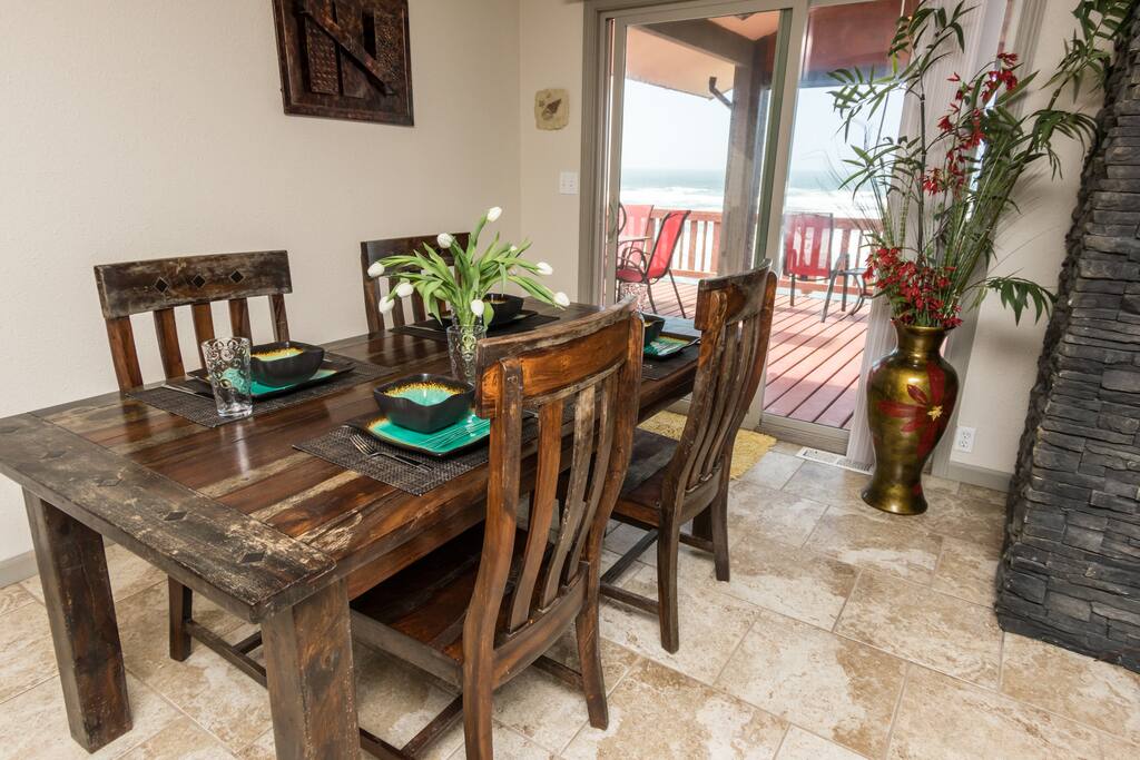 Open concept dining area that seats 4 with adjacent bar seating and ocean view.