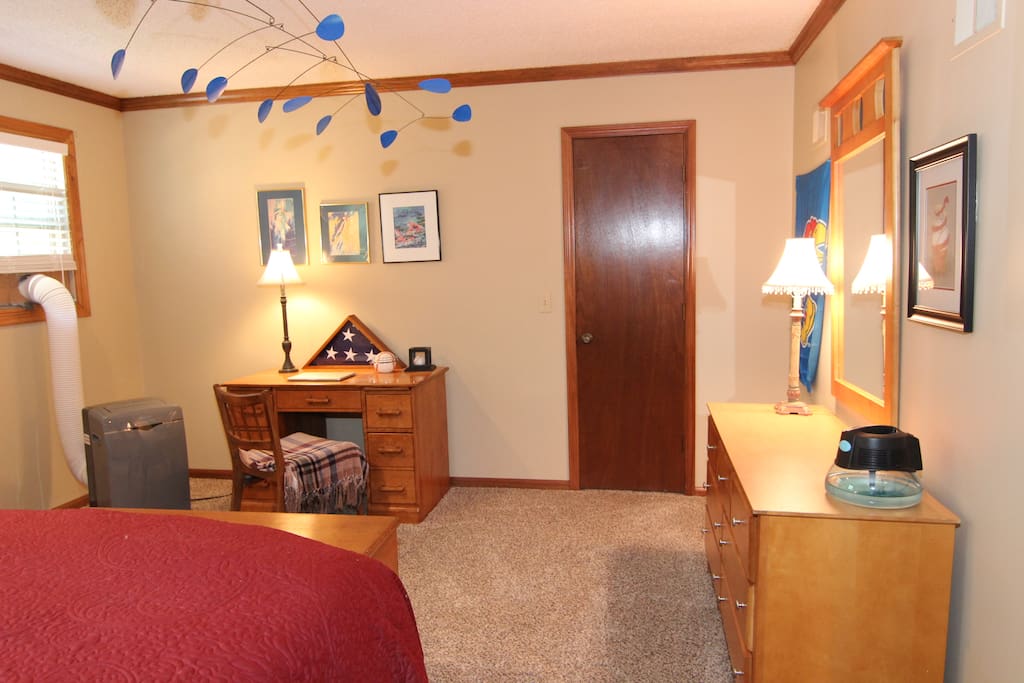 Room with desk facing walk-in closet