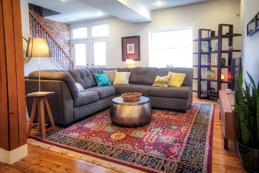 Living room with Apple TV and large comfy couch (can sleep two).