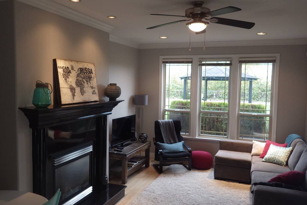 Cozy couch with blankets and pillows. An electric fireplace.