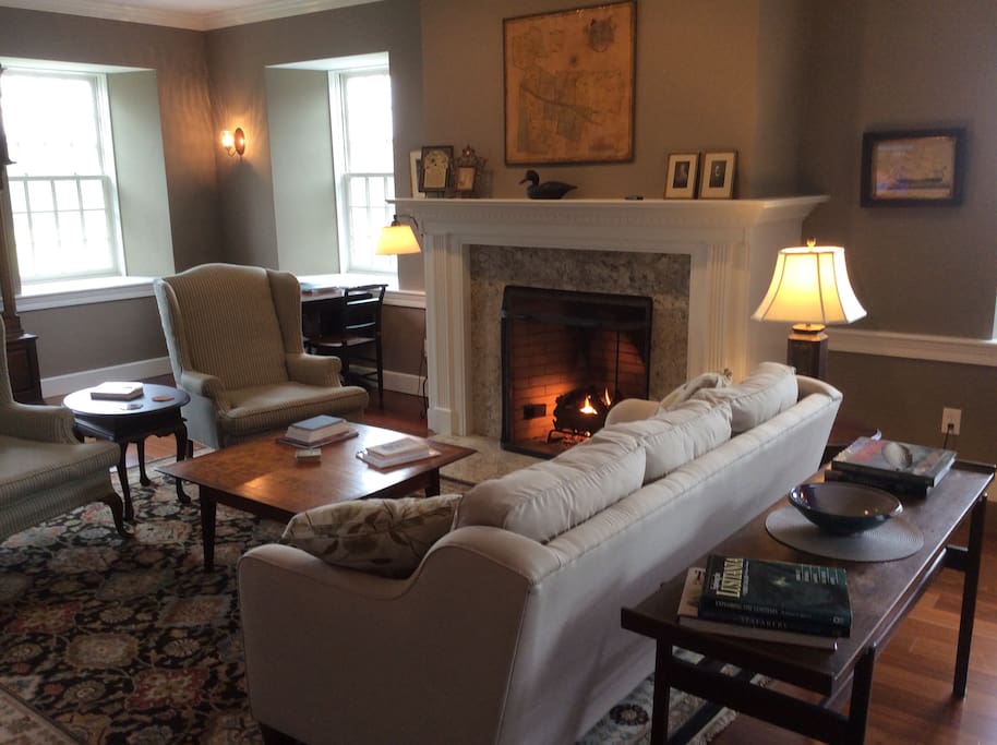 The Living room sitting area and fireplace. 30" flat-screen tv. Great place for quiet conversations or watching the morning news with a warm cup of coffee. Views of the Garden Lot and Long Island Sound to the south and the hayfield to the east.