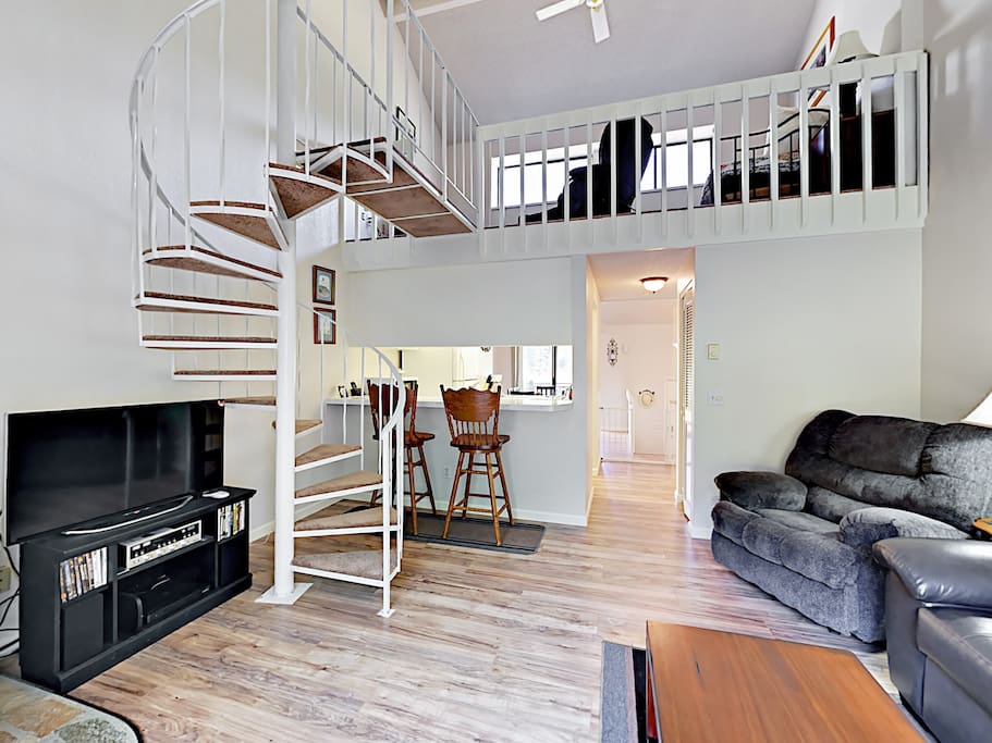 The open living area includes a 40" flat screen TV and plenty of seating.