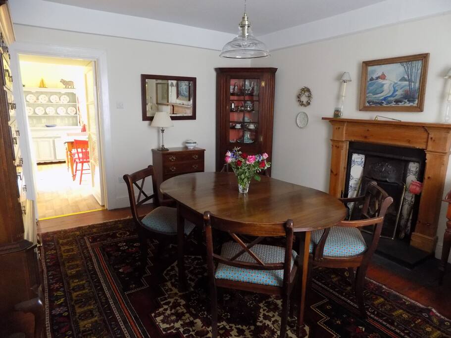 The dining room looking through to the dine-in kitchen. There is also a desk here by the front window.