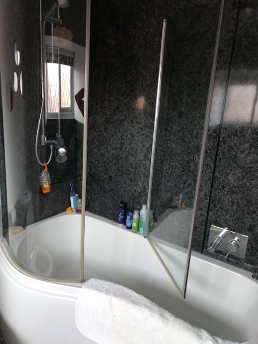 Bathroom with bath and power shower