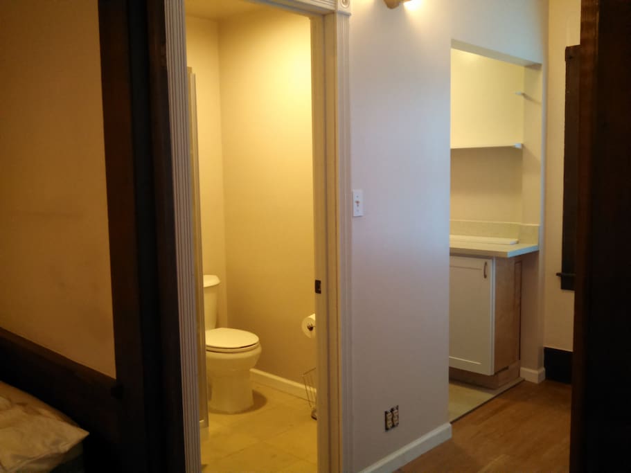 Sleek private bathroom separating sinks and remodeled countertops.