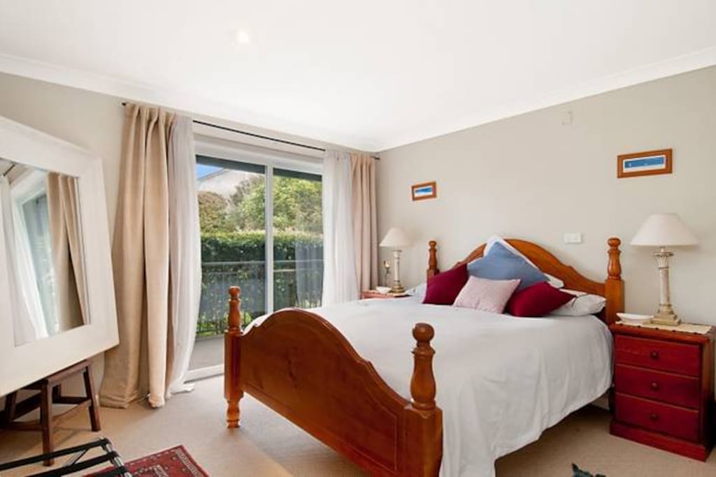 Comfortable queen size bed with screen door bringing in the freeze ocean breeze.