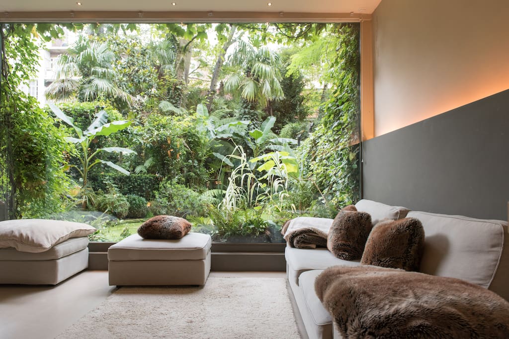 Living room with the XXL window to the tropical garden