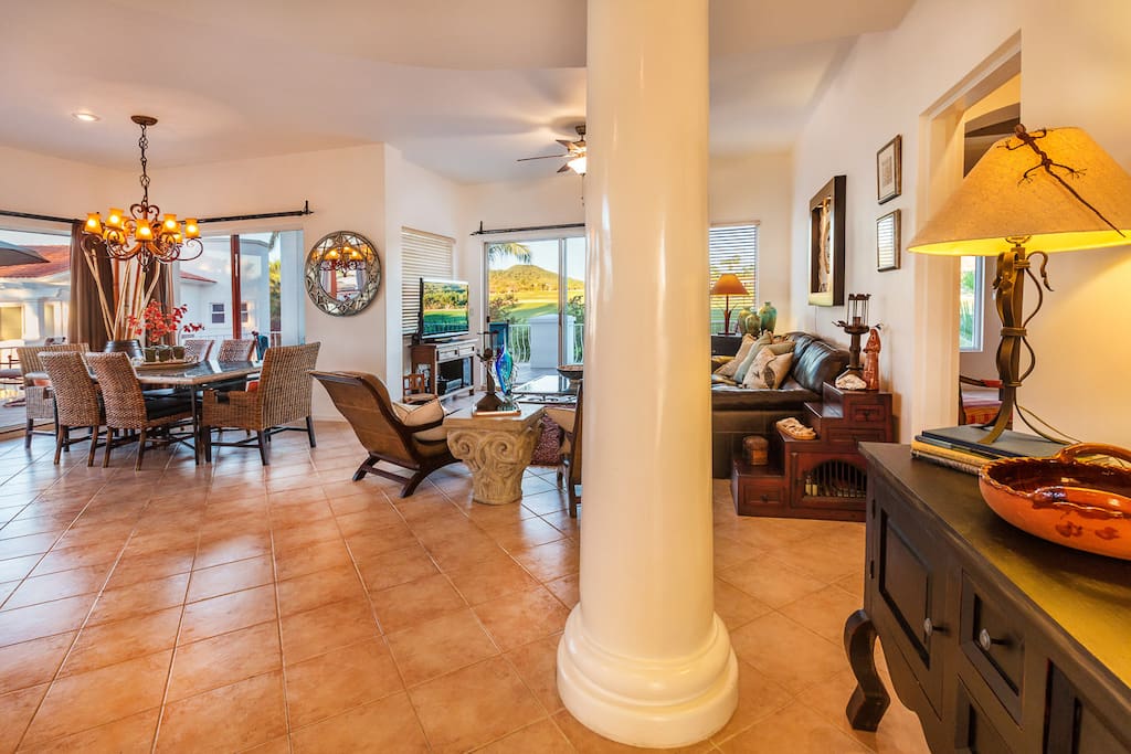 Open floor living room connecting with kitchen, dinner and outdoors