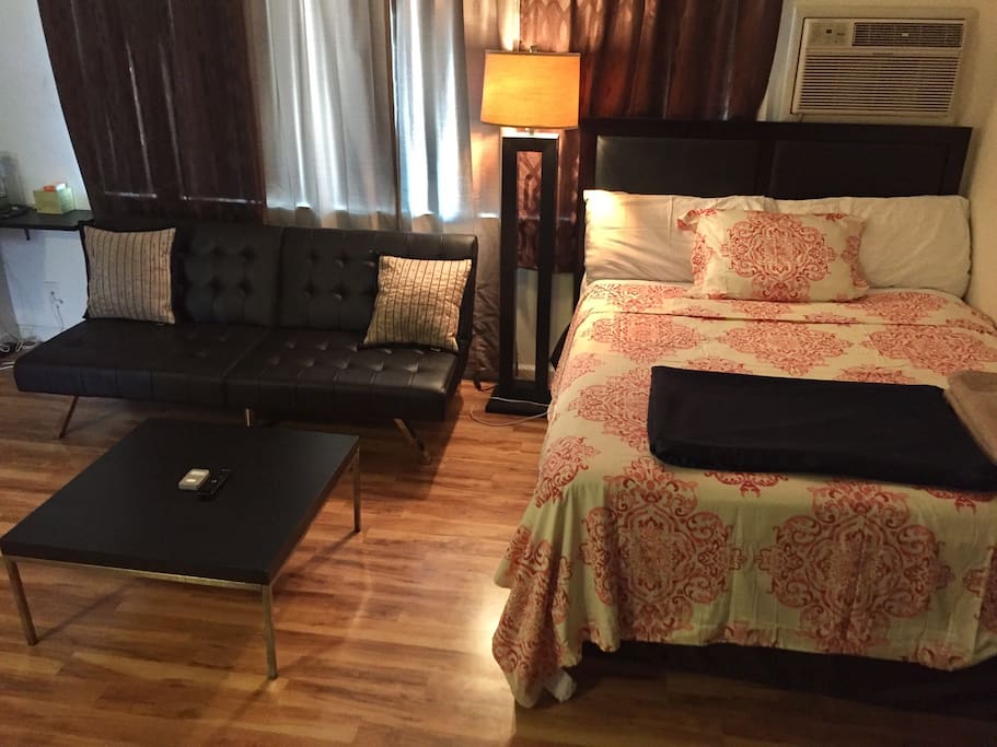 Comfortable pillow top queen bed with leather couch that turns into a pull out twin bed