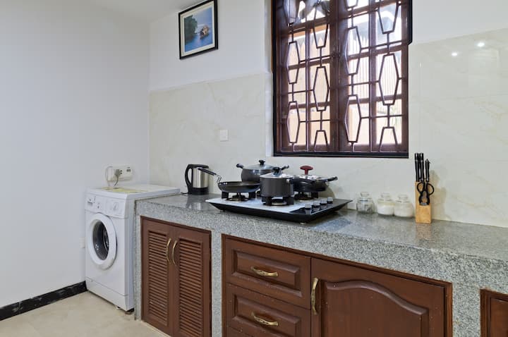 The kitchen is fully furnished with a fridge, freezer, kettle, washing machine, toaster, microwave, 4 ring gas stove with oven, cooking utensils, crockery and cutlery