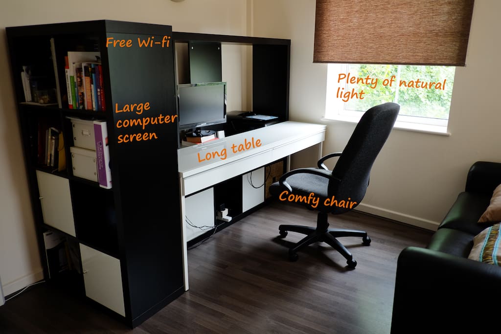 Comfy working area, with large desk, soft chair and a large computer screen. High-speed wi-fi