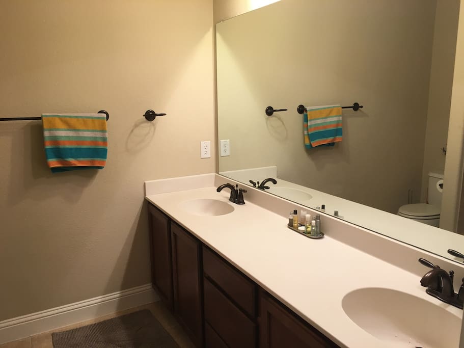 Private bath with double sink vanity and shower/bath
