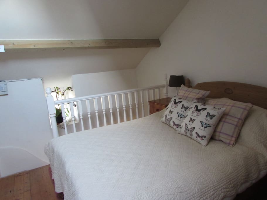 comfortable bed with wardrobe , chair , and velux window for star gazing