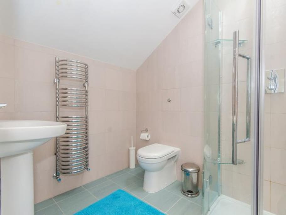 Light, airy shower room in loft, with skylight