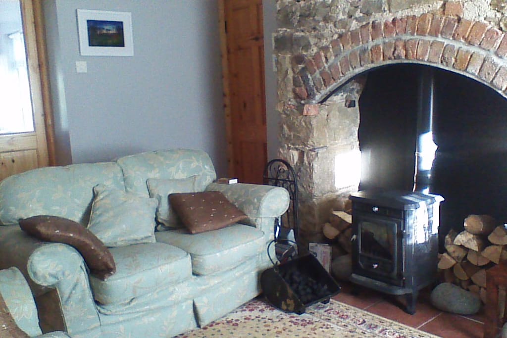 Old stone fireplace with cast iron stove