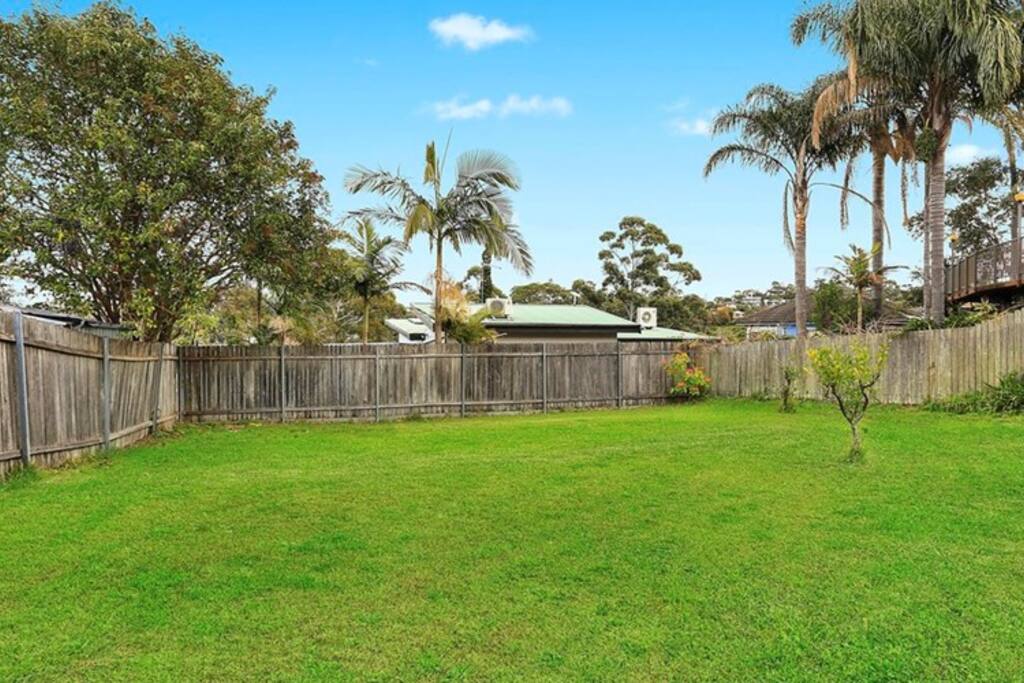 Massive backyard which now has a slippery slide and a trampoline