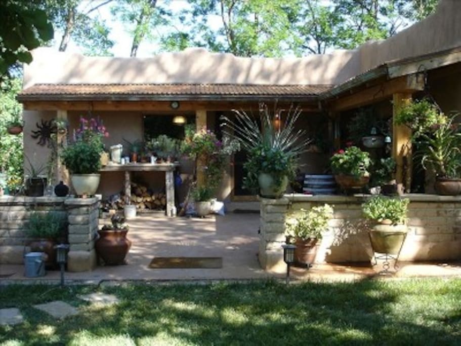 Front patio-flagstone, flowers, seating, BBQ and Art