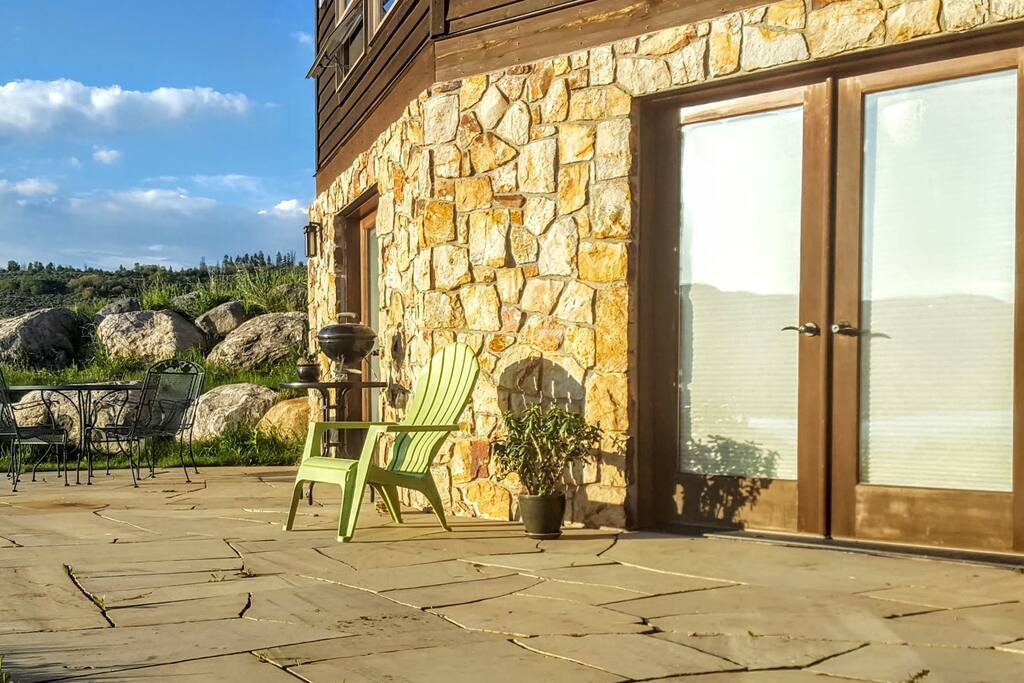 Your private flagstone patio: the perfect place to bask in the afternoon and evening sunlight, then watch the sun set over the lake and mountains. Complete with with wrought-iron table and chairs and mini grill for an al fresco dinner. Doors closest to the photo lead to the master bedroom; far doors lead to the living room. (If you look closely at the doors in this photo, you can see the reflection of the lake and mountains.)