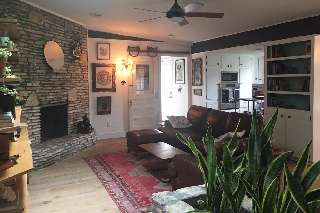 Natural light, stone fireplace, leather couch