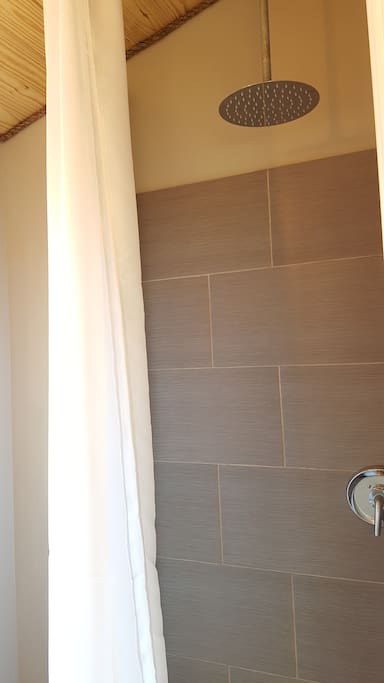 Shower area. To give you a height reference, the shower curtain is 96" tall, so this over sized rain-head shower really has a relaxing cascade effect, as it is mounted so high