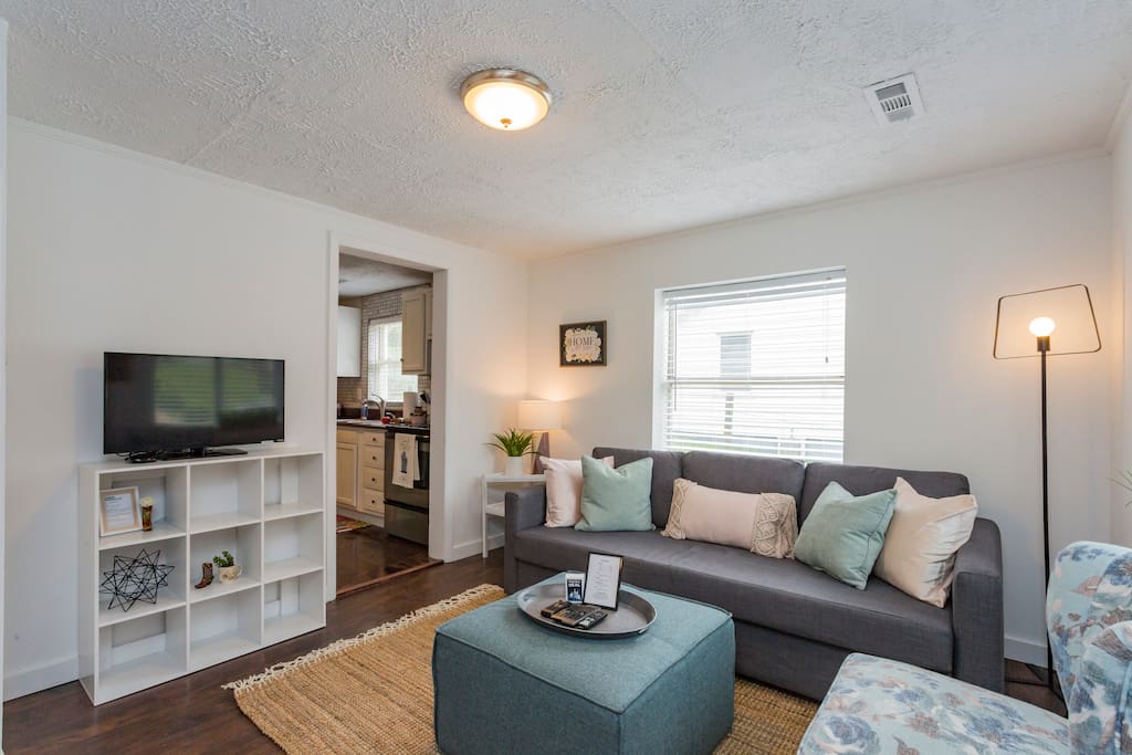 You'll be greeted by the main living space which features a spacious sofa and ottoman combination.