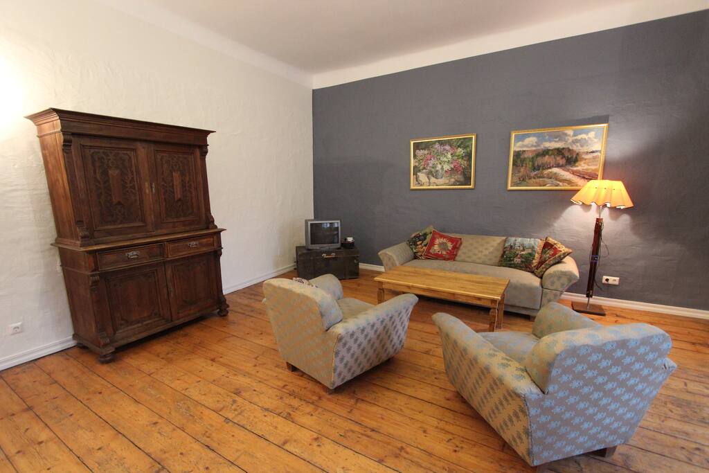 Spacious living room. Wall paintings feature Latvian, Mongolian, and local artists.