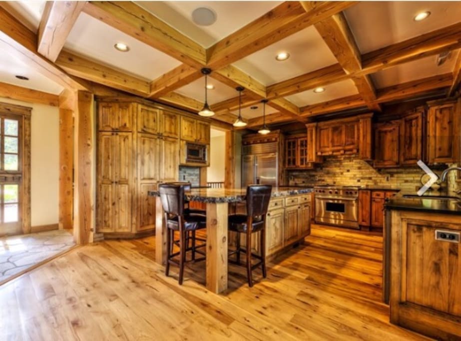 Gourmet Kitchen with Thick Slab Granite Center Island and Designer Appliances