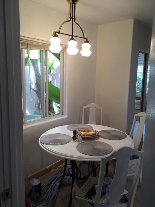 Dining nook in kitchen with view of lush walkway.