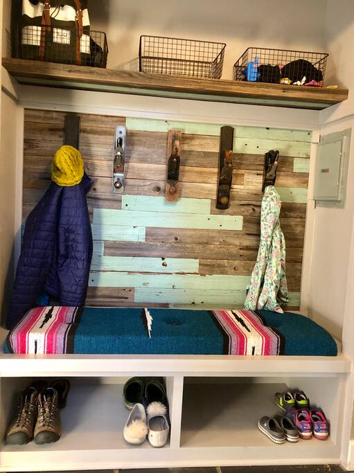 Entry station. Sit down, take your shoes off, and get comfortable. The perfect place to keep your items organized during your stay! Erik used reclaimed fence board and his dad found these cool hand planes.