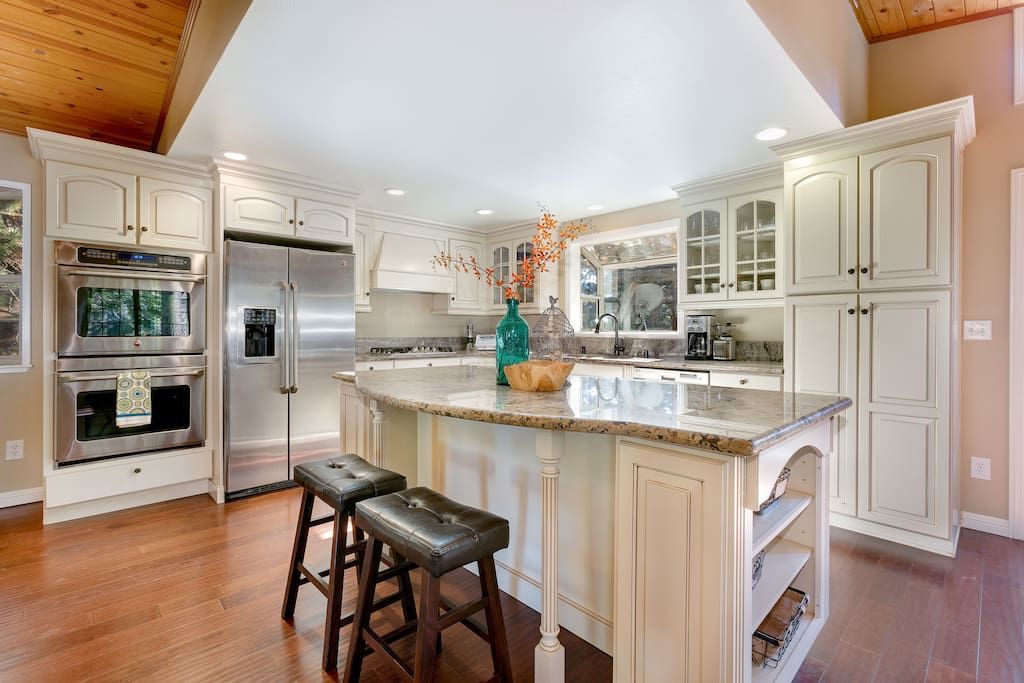 The gourmet kitchen features a large center island and double ovens.