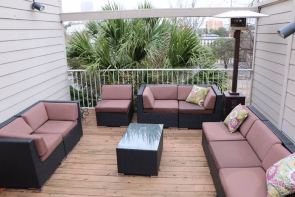 3rd floor patio seats 8, propane heater. View of downtown.