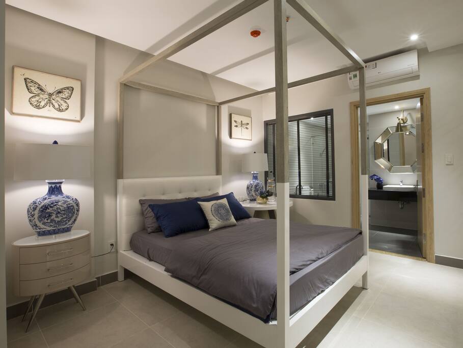 A master bedroom with a double bed and its own bathroom with shower
