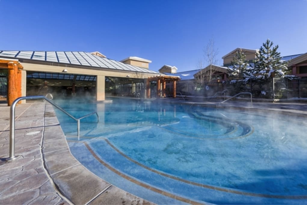 Indoor outdoor pool with two out door hot tubs.