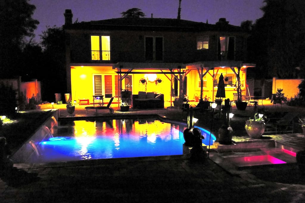 Backyard showing pool lights and waterfalls
