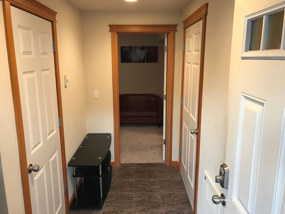 Shared front door entry to mud room. Stairs to the left go to the upstairs unit with a door at top.