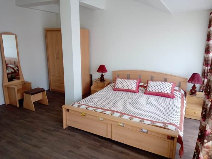 Bedroom 2 offers a king sized bed, closet, seating area and dressing table.