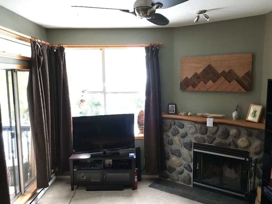Smart TV and fireplace. Balcony door on the left