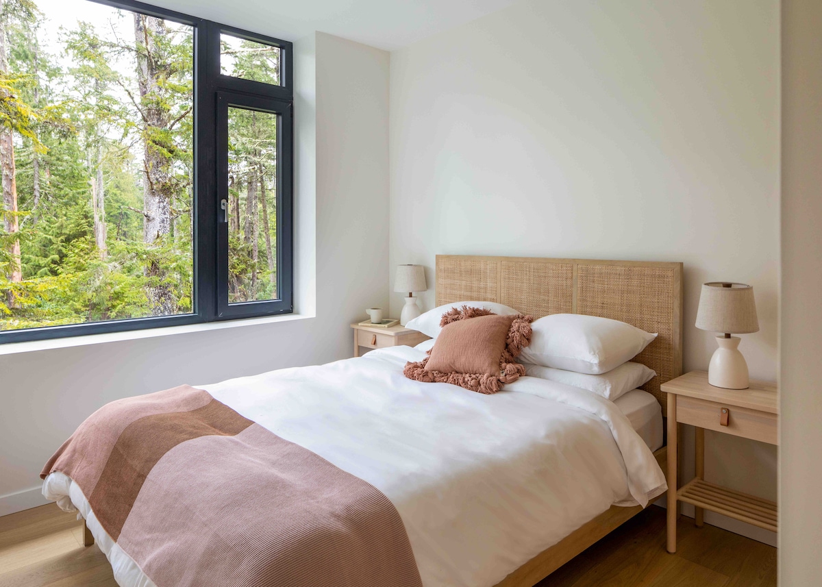 The second bedroom—featuring a Queen bed, luxe Brooklinen bedding, full closet, and beautiful forest views for a peaceful and rejuvenating rest
