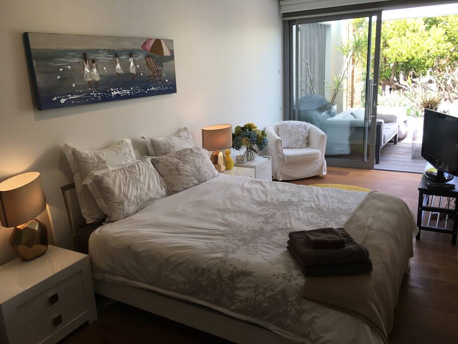 Bright and crisp room overlooking terrace garden.