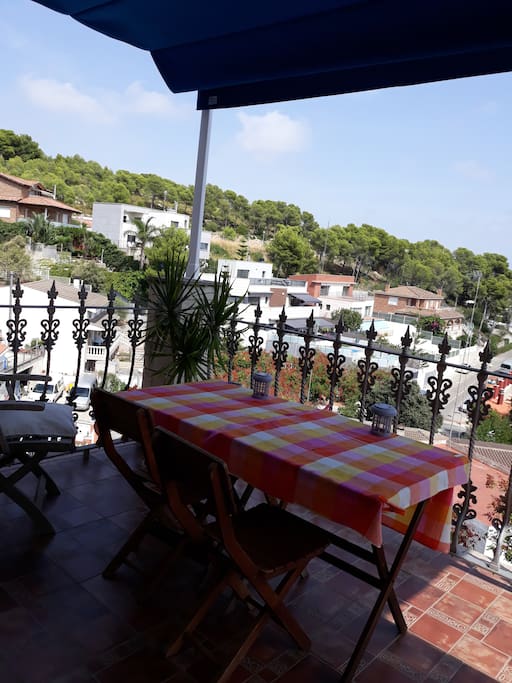 2017: Terrace with wooden furniture and new shading tent, view to garraf natural park