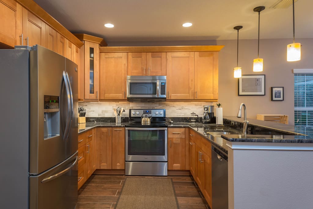 Beautiful kitchen with custom granite counters and stainless appliances.