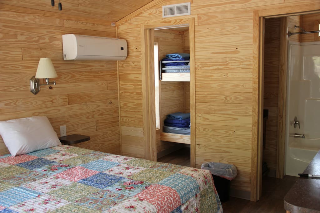 You can see a glimpse of the bathroom and bunk room but the main focus is the large queen sized bed.
