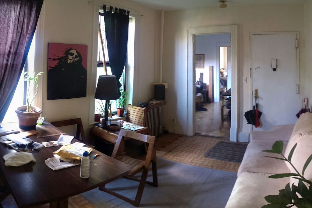 Alternative entrance, dining table, sofa, stereo.