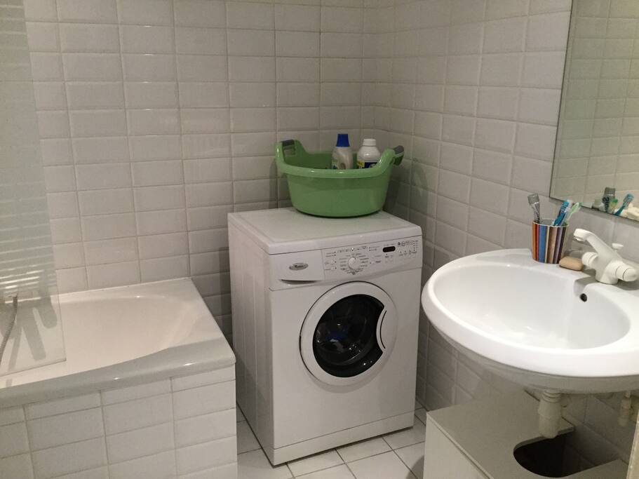 1st view of the bathroom, you can see the sink, the washing machine and the bath.