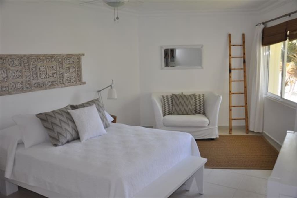 The master bedroom with queen sized bed, egyptian cotton bedding and view to the ocean.
