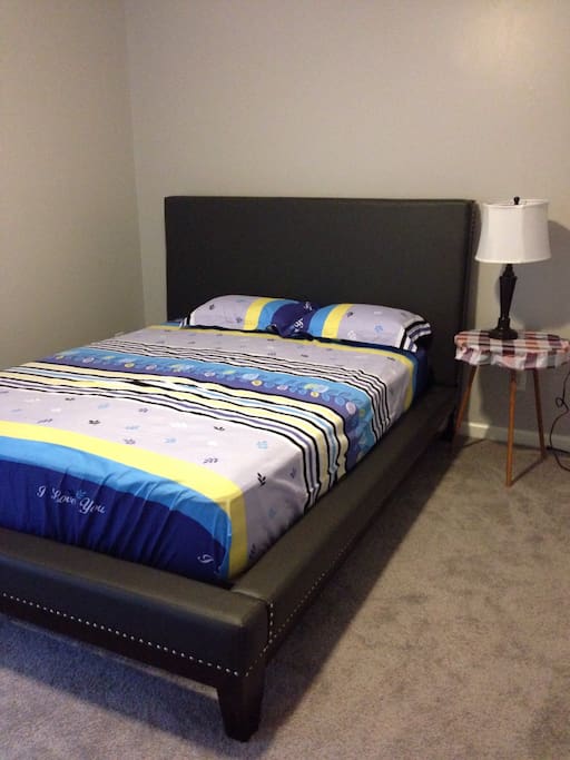A room with a queen size bed .big enough for two to sleep.