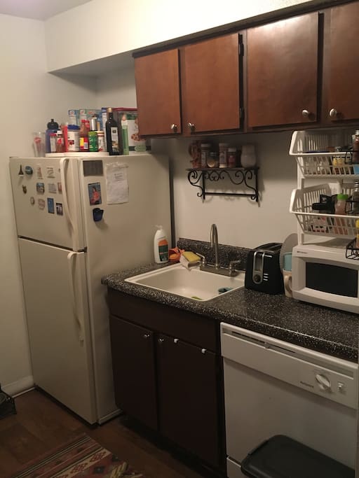 Kitchen with refrigerator, microwave, dishwasher, and electric stove.