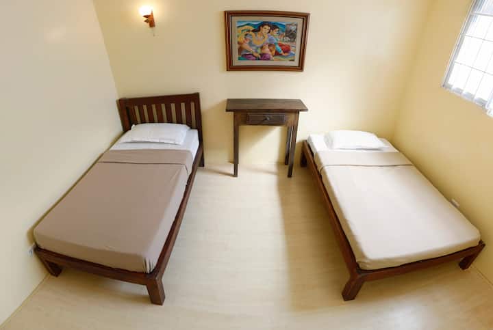Bedroom 3. Equipped with two single sized bed for 2 with an option to add an extra mattress. Comes with air conditioner and ceiling fan
